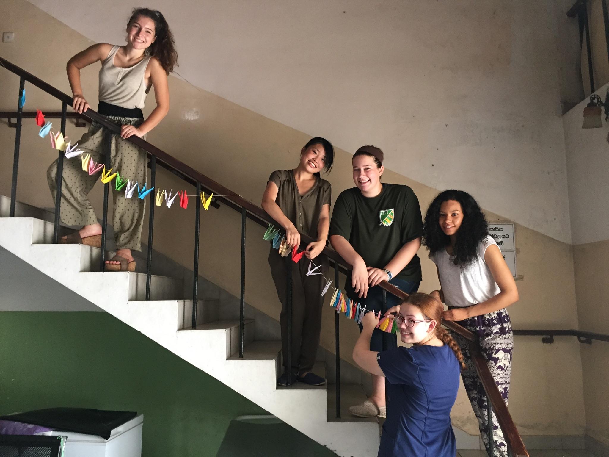 Projects Abroad interns hang origami at our Dentistry placement for high school students in Sri Lanka Teenagers hang origami decorations around a clinic during their Dentistry internship in Sri Lanka
